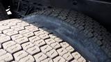 Close-up of two large truck tires showing detailed tread patterns and wear on a 2003 International 5600i