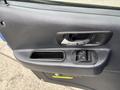 Close-up of the door handle and window controls of a 2017 Autocar Xpert featuring a silver handle and two buttons for window operation