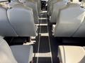 Interior view of a 2013 International CE300 school bus showing a row of gray vinyl seats arranged in two columns with a central aisle