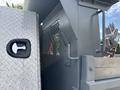 Close-up of a locked compartment on a 2016 RAM 5500 truck with a metallic finish and a textured surface adjacent to a sturdy tool storage area