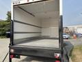 A 2008 Ford Econoline truck with an empty cargo space featuring a metal floor and white walls