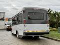 A 2019 Chevrolet Express bus with a white and gray exterior displaying tail lights and a black rear window