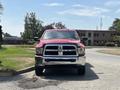 A red 2013 RAM 2500 truck parked with a shiny chrome grille facing forward