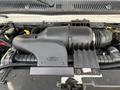 Close-up of the engine compartment of a 2002 Ford Econoline featuring the air intake system and various engine components