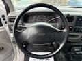 The interior view of a 2000 Ford F-450 showing the steering wheel dashboard and control panel with various gauges and buttons