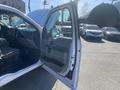 A 2017 Ford F-150 truck with the driver's door open showcasing the interior features and seating arrangement