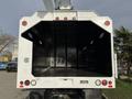 A 2011 International 4300 truck with an open cargo area showcasing a spacious interior designed for utility work