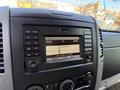 Dashboard display of a 2016 Mercedes-Benz Sprinter featuring an audio system with radio settings and frequency information