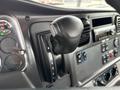 The interior of a 2021 Freightliner M2 106 showcasing the gear shift lever positioned next to the dashboard controls and gauges