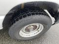Close-up of a tire mounted on a wheel showcasing deep treads on a 2009 Ford Econoline vehicle