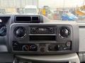 Dashboard of a 2022 Ford E-450 featuring a stereo system and various control knobs for temperature and ventilation
