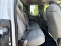Interior view of a 2017 Ford F-550 showing gray cloth seats in the rear row with seat belts fastened