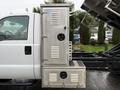 A 2015 Ford F-450 with a polished metal utility box featuring multiple storage compartments and lockable doors mounted on the side of the truck