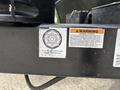 A metallic label on a trailer indicating torque specifications with a circular diagram and warning information about securing lug nuts