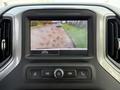 A rearview camera display showing the back of a 2024 Chevrolet Silverado 1500 with guiding lines for parking assistance