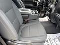 Interior view of a 2019 Chevrolet Silverado 1500 showing the driver's side seat and center console with cup holders and storage compartments