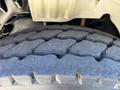 Close-up of a heavily treaded tire from a 2006 Freightliner M2 106 showcasing deep grooves for traction and wear on the rubber surface