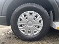 A close-up of a wheel from a 2021 Ford Transit-350 featuring a silver hubcap and a black tire with visible tread pattern