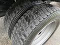 Close-up of a 2016 Ford F-550 Super Duty tire showing detailed tread pattern and sidewall design with dirt and wear marks visible