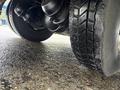 Close-up of the tire and wheel assembly of a 2011 Ford F-650 showing tread pattern and suspension components