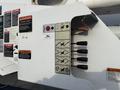 Close-up view of the control panel on a 2013 International Durastar 4300 featuring various labeled switches and valves for operational functions
