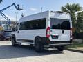 A white 2022 RAM Promaster 350 van parked with a wheelchair access sticker displayed on the rear and custom black rims