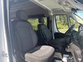 Interior view of a 2022 RAM Promaster 350 showing two gray fabric front seats with adjustable headrests and a driver's seat with armrest