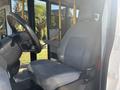 Interior view of a 2017 Ford Transit-350 showing a driver's seat with gray upholstery and steering wheel