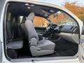 Interior view of a 2013 Toyota Tacoma showing front seats gray fabric and dashboard with steering wheel and controls visible