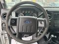 Steering wheel and dashboard of a 2014 Ford F-550 displaying gauges and controls