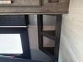 Interior shelves of a 2021 Jayco Jay Flight camper showing a wooden frame and textured walls