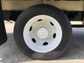 Close-up of a white wheel rim mounted on a black tire from a 2018 Hino 195 truck