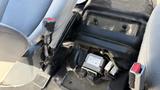 The interior cabin of a 2016 Ford F-150 showing the floor area between the front seats with exposed components and wiring