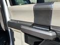 Interior door handle of a 2019 Ford F-550 with a textured surface and a sleek design