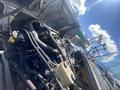 A 1997 Freightliner FL70 showing its engine compartment with visible hoses and tanks