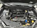 A 2016 Subaru Forester engine compartment displaying various engine components such as the air intake system battery and fluid reservoirs