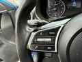 Close-up of the steering wheel with control buttons and instrument cluster of a 2021 Kia Forte