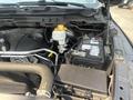 A 2015 RAM 1500 truck engine compartment featuring the battery coolant reservoir and various engine components clearly visible