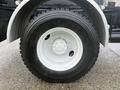 Close-up of a white wheel rim with a black tire marked with the size 11R22.5 and brand name Michelin on a 2016 Freightliner 108SD truck