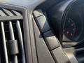 A close-up view of the dashboard controls of a 2019 Ford Transit 350 highlighting buttons for traction control and headlights along with a speedometer needle