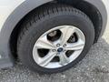 Close-up of a silver 2015 Ford Escape tire showcasing an alloy wheel with five spokes and a Toyo tire mounted on it