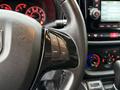 Close-up of the steering wheel of a 2017 RAM ProMaster City featuring controls for cruise settings and audio system