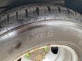 A close-up of a tire mounted on a wheel showcasing the tread pattern and markings for a 2020 Chevrolet Express