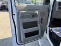 Driver's side door of a 2016 Ford Econoline with gray interior paneling and controls clearly visible