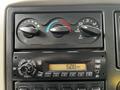 Dashboard controls of a 2011 International 4400 featuring climate control knobs and a radio display indicating the time as 6:08 AM