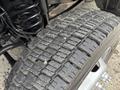 Close-up of a 2018 Ford F-550 tire showing detailed tread pattern and texture on a muddy surface