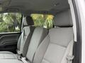 Interior of a 2016 GMC Sierra 1500 showing front seats in grey fabric with seat belts and headrests