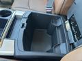The image shows the interior center console of a 2015 RAM 1500 featuring a storage compartment with a removable insert and cup holder sections