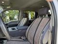 Interior view of a 2018 Ford F-150 showing the front seats with patterned fabric and a center console