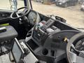 Interior view of a 2017 Autocar Xpert dashboard featuring steering wheel controls a display screen and various instrument panel buttons